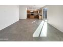 Open concept kitchen with maple cabinets and tiled floors at 13481 W Buckskin Trl, Peoria, AZ 85383