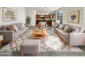 Bright living room featuring stylish couches, modern decor, and view to the kitchen at 13481 W Buckskin Trl, Peoria, AZ 85383