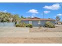 A single story blue brick home featuring desert landscaping and a paved driveway, under a clear blue sky at 140 W University Dr, Mesa, AZ 85201