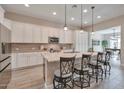 Modern kitchen boasts an island with seating, stainless steel appliances, and ample cabinet space at 16911 W Palm Ln, Goodyear, AZ 85395