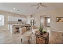 Open concept kitchen with white cabinets, granite countertops, stainless steel appliances, and a breakfast bar at 16955 W Cypress St, Goodyear, AZ 85395