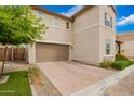 Side view of the property showcasing the two-car garage and brick-paved driveway at 17160 N 9Th Pl, Phoenix, AZ 85022