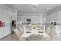 Bright kitchen with stainless steel appliances, white cabinetry, and an island with bar seating at 17827 W Medlock Dr, Litchfield Park, AZ 85340