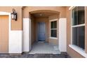 Welcoming covered entryway featuring a stylish blue front door, decorative columns and side window at 17841 W Windsor Blvd, Litchfield Park, AZ 85340