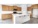 Bright kitchen with a kitchen island, stainless steel appliances, and stylish cabinetry at 17841 W Windsor Blvd, Litchfield Park, AZ 85340