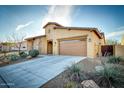 Beautiful home featuring a two-car garage, desert landscaping, and a covered porch entry at 18107 W Thunderhill Pl, Goodyear, AZ 85338