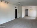 Bright living room featuring new carpet and ceiling fan at 1822 E Roma Ave, Phoenix, AZ 85016