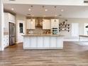 Bright, open kitchen with stainless steel appliances, granite countertops, and center island with pendant lighting at 1892 S Arroyo Ln, Gilbert, AZ 85295