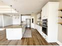 Modern kitchen with white cabinets, stainless steel appliances, and a large island with granite countertops at 1892 S Arroyo Ln, Gilbert, AZ 85295