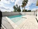Sparkling swimming pool surrounded by travertine tile, perfect for relaxing or entertaining at 1892 S Arroyo Ln, Gilbert, AZ 85295