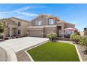 Charming two-story home featuring a spacious three-car garage, long driveway and well manicured lawn and backyard patio at 19616 N Toya St, Maricopa, AZ 85138