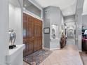 Grand foyer featuring double doors, tile flooring, and an elegant display niche with views to other rooms at 2452 W Enfield Way, Chandler, AZ 85286