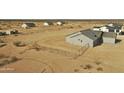 Aerial view showing desert home's fenced lot featuring a large backyard at 25721 W Running Deer Trl, Wittmann, AZ 85361