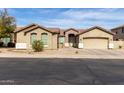 Charming single-story home featuring a well-manicured front yard and a two-car garage at 2612 W Summerside Rd, Phoenix, AZ 85041