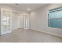 Bright office space featuring a large window and double doors at 26696 W Siesta Ln, Buckeye, AZ 85396