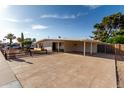 The charming single-story home has desert landscaping and a spacious driveway with covered parking at 3632 E Poinsettia Dr, Phoenix, AZ 85028