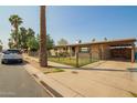 Charming single-story home featuring a gated front yard and covered carport at 3736 W Hazelwood St, Phoenix, AZ 85019