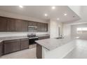 Modern kitchen features granite countertops, stainless appliances, and open layout at 4107 S 176Th Dr, Goodyear, AZ 85338