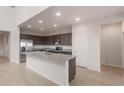 Bright, spacious kitchen with stainless steel appliances and a large center island at 4107 S 176Th Dr, Goodyear, AZ 85338