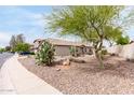 Attractive single-story home displaying desert landscaping and privacy on a corner lot at 41580 W Sunland Dr, Maricopa, AZ 85138