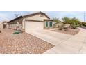 Attractive home showcasing desert landscaping and a convenient two-car attached garage at 41580 W Sunland Dr, Maricopa, AZ 85138