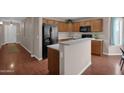 Kitchen boasting light countertops and wooden cabinets, with an island and black appliances at 4364 S Tatum Ln, Gilbert, AZ 85297