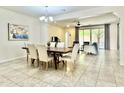 Open-concept dining area with a wooden table, comfortable seating and adjacent living space at 4417 N 156Th Dr, Goodyear, AZ 85395