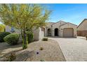 Inviting single-story home boasts a beautiful desert landscape, tile roof, and neutral-toned exterior at 4417 N 156Th Dr, Goodyear, AZ 85395