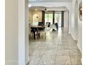 View of the open living space, showing dining table and living area with neutral decor and tiled floors at 4417 N 156Th Dr, Goodyear, AZ 85395