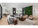 This bright, airy living room features a cozy seating area with views into the kitchen and backyard at 4901 E Lafayette Blvd, Phoenix, AZ 85018