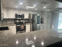 Updated kitchen featuring granite counters, stainless steel appliances and white cabinets at 5537 E Drummer Ave, Mesa, AZ 85206