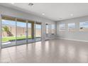 Bright living room with neutral walls and a sliding glass door leading to the backyard at 5619 N 193Rd Ave, Litchfield Park, AZ 85340