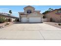 Two story home featuring a neutral color scheme, red roof, landscaping, and a spacious three car garage at 5959 W Lone Cactus Dr, Glendale, AZ 85308