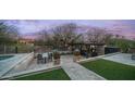 Inviting outdoor area with TV, fireplace, desert landscaping, and a spacious dining area at 6009 E Dale Ln, Cave Creek, AZ 85331