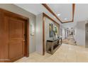 Hallway view with travertine floor, decor niche, and wood door with unit number at 6803 E Main St # 1106, Scottsdale, AZ 85251
