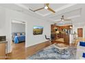 Open-concept living room and kitchen with modern decor and hardwood flooring at 6803 E Main St # 1106, Scottsdale, AZ 85251