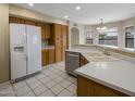 Kitchen featuring white appliances, wooden cabinets, and bright white countertops at 7009 W Taro Ln, Glendale, AZ 85308
