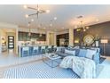 Open-concept living area featuring a comfortable sofa, modern kitchen, and seamless flow for entertaining at 7330 E Vista Bonita Dr, Scottsdale, AZ 85255
