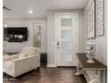Bright entryway showcases a modern front door, stylish console table, and wood flooring at 10260 E White Feather Ln # 1022, Scottsdale, AZ 85262