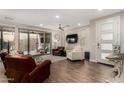 Spacious living room with wood floors, a ceiling fan, and sliding glass doors to the outdoor living space at 10260 E White Feather Ln # 1022, Scottsdale, AZ 85262