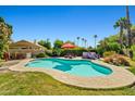 Relaxing backyard pool and spa area with lounge chairs and mature landscaping at 10837 W Cottonwood Ln, Avondale, AZ 85392