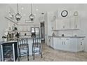 Bright kitchen boasts white cabinetry, granite countertops, stainless appliances, and a convenient breakfast bar at 10939 N 111Th St, Scottsdale, AZ 85259