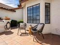 A cozy outdoor patio featuring a tiled floor, stylish seating, potted plants, and a tranquil atmosphere at 1110 N Gull Haven Ct, Gilbert, AZ 85234