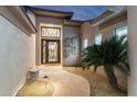 Stylish entryway with stone pathway, desert landscaping, and unique front door design at 11339 E Beck Ln, Scottsdale, AZ 85255
