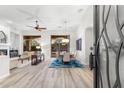 Open-concept living room and dining area with wood floors, fireplace, and access to outdoor patio at 11339 E Beck Ln, Scottsdale, AZ 85255