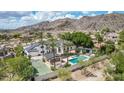 Backyard with a pool, spa, tennis court, and covered patio, providing a private outdoor retreat at 11827 S Montezuma Ct, Phoenix, AZ 85044