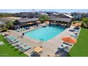 Community pool with ample seating for residents to relax and enjoy the sun at 14639 W Sand Hills Rd, Surprise, AZ 85388
