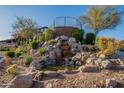Beautiful water feature with stone accents and desert landscaping in a community setting at 16336 E Ridgeline Dr, Fountain Hills, AZ 85268