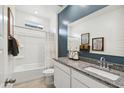 Well-lit bathroom featuring a granite countertop, modern fixtures, and a shower-tub combo with tile surround at 18823 E Bruno Dr, Gold Canyon, AZ 85118