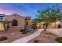 Charming home with desert landscaping, stone accents, and a winding walkway to the inviting entrance at 1916 E Dubois Ave, Gilbert, AZ 85298